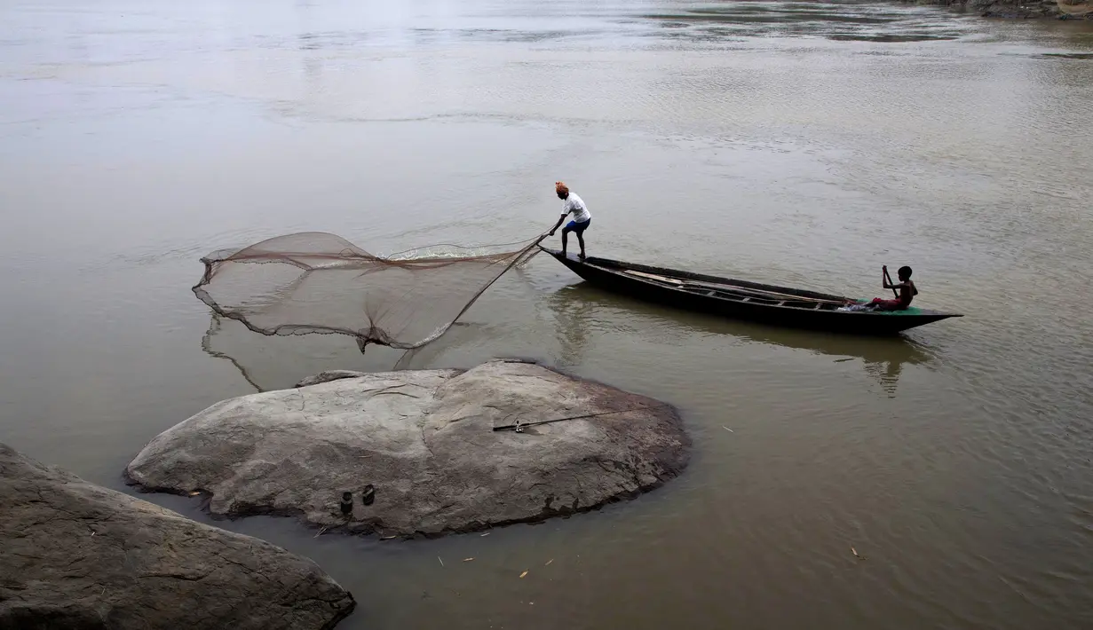 Seorang nelayan melempar jaring ikan menangkap ikan di sungai Brahmaputra di desa Kasoshila di Gauhati, India (21/10/2019). Brahmaputra adalah salah satu sungai terbesar di Asia, yang melewati wilayah Tibet China, India, dan Bangladesh sebelum konvergen ke Teluk Benggala. (AP Photo/Anupam Nath)