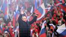 Presiden Rusia Vladimir Putin menyapa orang-orang setelah pidatonya di konser perayaan  delapan tahun referendum tentang status negara bagian Krimea dan Sevastopol serta penyatuannya kembali dengan Rusia, di Moskow, Rusia (18/3/2022). (Ramil Sitdikov/Sputnik Pool Photo via AP)