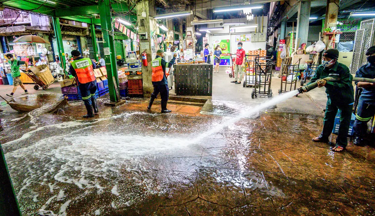 Karyawan Otoritas Metropolitan Bangkok membersihkan dan mendisinfeksi Pasar Bunga Yodpiman di Bangkok (6/1/2021).  Pemerintah memberlakukan pembatasan lebih lanjut karena wabah virus Corona Covid-19 baru-baru ini. (AFP/Mladen Antonov)