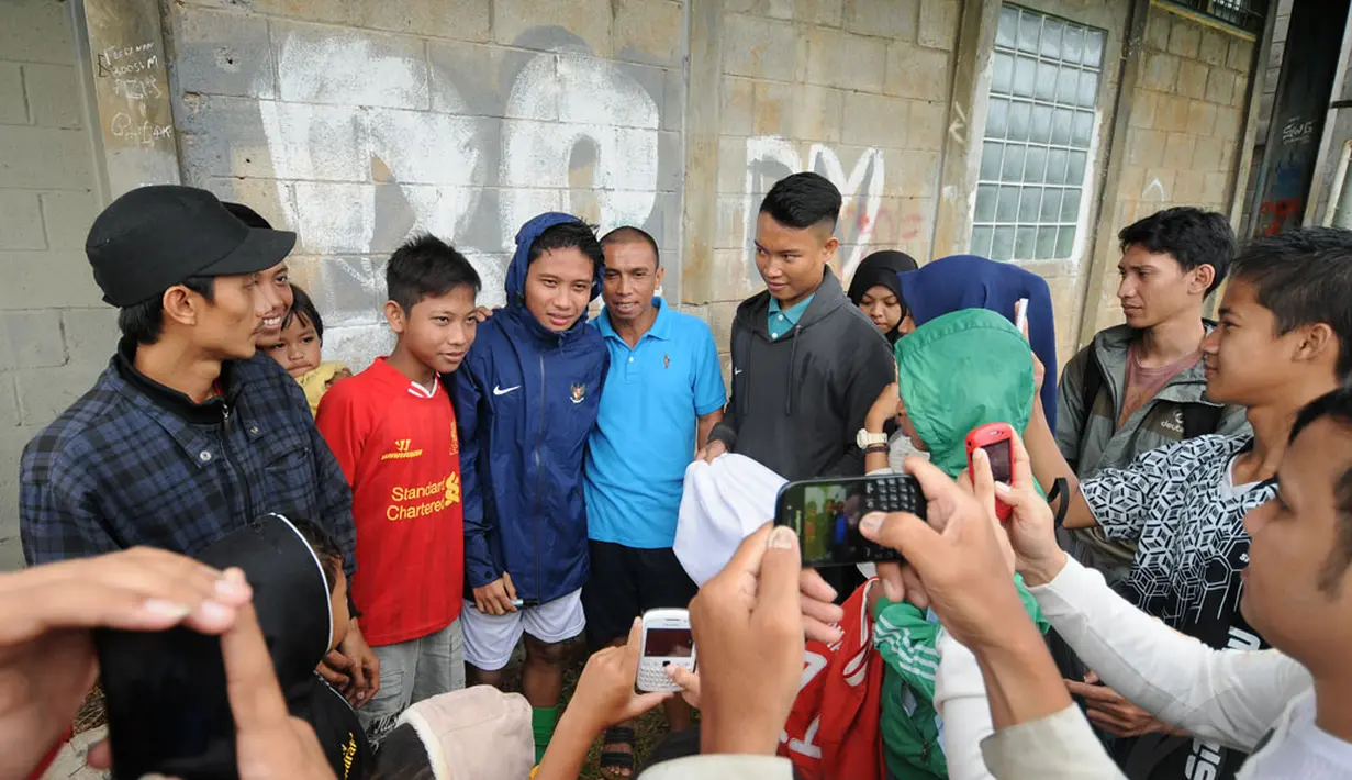 Penyerang Timnas U-23 Indonesia, Evan Dimas diserbu penggemarnya usai melakukan latih tanding dengan sejumlah pemain asing di POR Sawangan, Depok, Rabu (31/12/2014). (Liputan6.com/Helmi Fithriansyah)