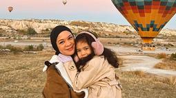 Wahana balon udara yang berada di Cappadocia merupakan salah satu tempat ikonik yang tidak mungkin untuk dilewatkan. Seperti halnya Tantri Namirah bersama buah hatinya yang tampil kompak, liburan keluarga ini kesini tentu menyenangkan. (Liputan6.com/IG/@haykalkamil)