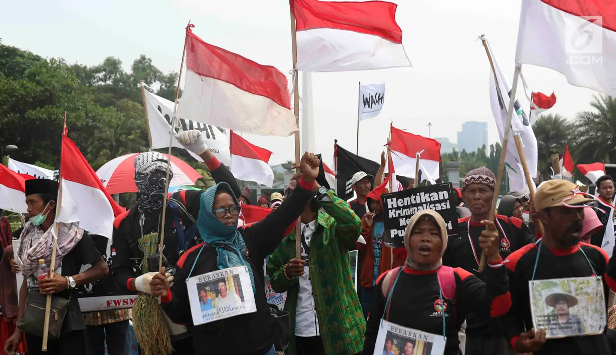 Petani dari Jakarta, Jawa Barat, dan Jawa Tengah bersama WALHI membawa Bendera Merah Putih saat unjuk rasa menolak kriminalisasi aktivis lingkungan hidup di depan Istana Negara, Jakarta, Kamis (11/12). (Liputan6.com/Immanuel Antonius)