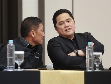 Ketua Persatuan Sepak Bola Seluruh Indonesia (PSSI), Erick Thohir, berbincang dengan Direktur Utama PT Liga Indonesia Baru (LIB) Ferry Paulus, saat jumpa pers di Menara Danareksa, Jakarta Pusat, Kamis (20/6/2024). (Bola.com/M Iqbal Ichsan)