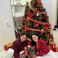 Amanda Manopo untuk pertama kalinya merayakan Natal sebagai istri dari Kenny Austin. Berfoto di pohon Natal, Amanda tampil dengan atasan knit lengan panjang dipadu rok pleated putih. [@amandamanopo]
