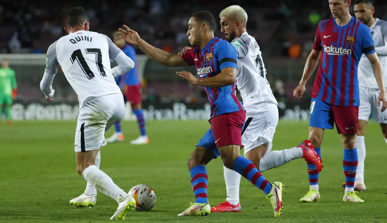 Bek Barcelona, Sergino Dest (tengah) berebut bola dengan gelandang Granada, Monchu pada lanjutan La Liga di Camp Nou, Selasa (21/9/2021) dini hari WIB. Barcelona dipaksa bermain imbang 1-1 oleh tamunya Granada. (AP Photo/Joan Monfort)