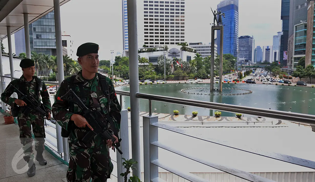 Aparat keamanan berjaga di jembatan penyeberangan orang (JPO) kawasan Bundaran HI, Jakarta, (5/3). Pengamanan dan Sterilisasi dilakukan jelang Konferensi Tingkat Tinggi Luar biasa Organisasi Kelompok Islam (KTT Luar Biasa OKI). (Liputan6.com/JohanTallo)