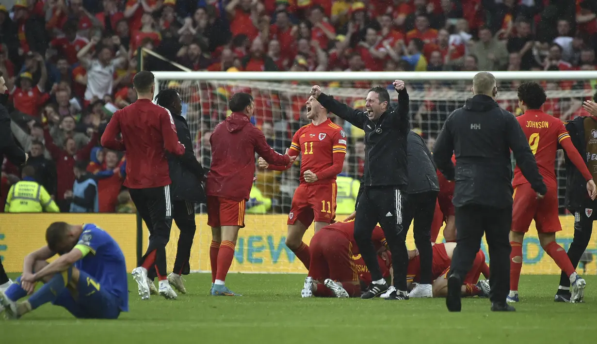 Para pemain Wales merayakan kemenangan atas Ukraina pada pertandingan play-off kualifikasi Piala Dunia 2022 di Stadion Cardiff City, di Cardiff, Wales, Minggu (5/6/2022). Wales lolos ke Piala Dunia setelah 64 tahun. (AP Photo/Rui Vieira)