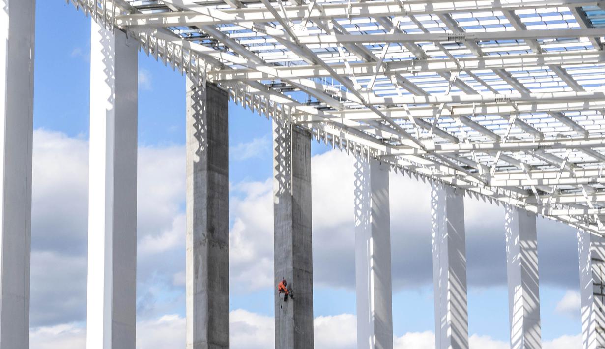 Pekerja saat menyelesaikan proyek pembangunan Stadion Nizhny Novgorod, Rusia, Selasa (19/9/2017). Stadion ini merupakan salah satu dari 12 stadion yang akan digunakan untuk perhelatan akbar Piala Dunia 2018 di Rusia. (AFP/Mladen Antonov)