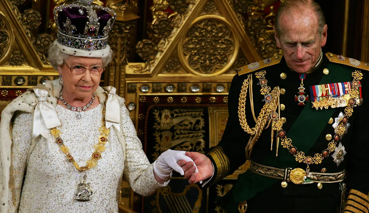 Pangeran Philip dari Inggris (kanan) memegang tangan Ratu Elizabeth II setelah dia berbicara kepada para politisi di 'State Opening Of Parliament' di London pada 15 November 2006. (ADRIAN DENNIS / POOL / AFP)
