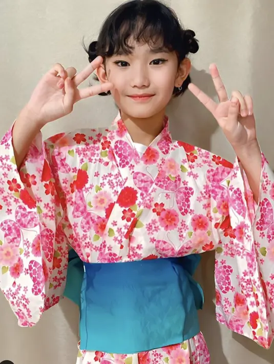 Hanbok bermotif floral juga membuat tampilan Bilqis terlihat semakin menggemaskan. Dominasi warna pink kontras dengan obi biru. Gaya rambut kepang juga menambah kesempurnaan gaya yang menjanjikan. [Foto: Instagram/ Ayutingting]