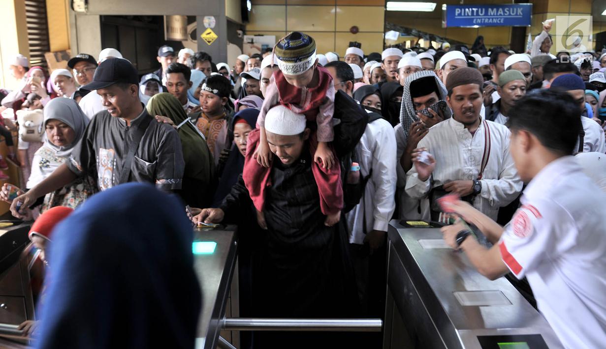 Peserta Reuni 212 berdesakan saat menuju pintu keluar Stasiun Gondangdia, Jakarta, Minggu (2/12). Antrean tersebut terkait acara Reuni 212 yang digelar di Monumen Nasional atau yang populer dengan Monas. (Merdeka.com/Iqbal S. Nugroho)
