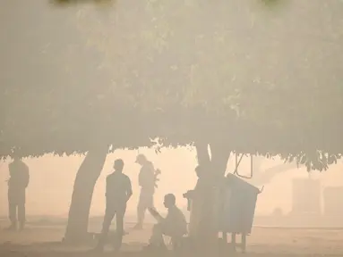 Polisi berjaga di sebuah taman umum diselimuti kabut polusi setelah perayaan Diwali di New Delhi, India (31/10). Kabut asap tebal yang menyelimuti Kota New Delhi mengancam kesehatan para warga setempat. (Reuters/Cathal McNaughton)