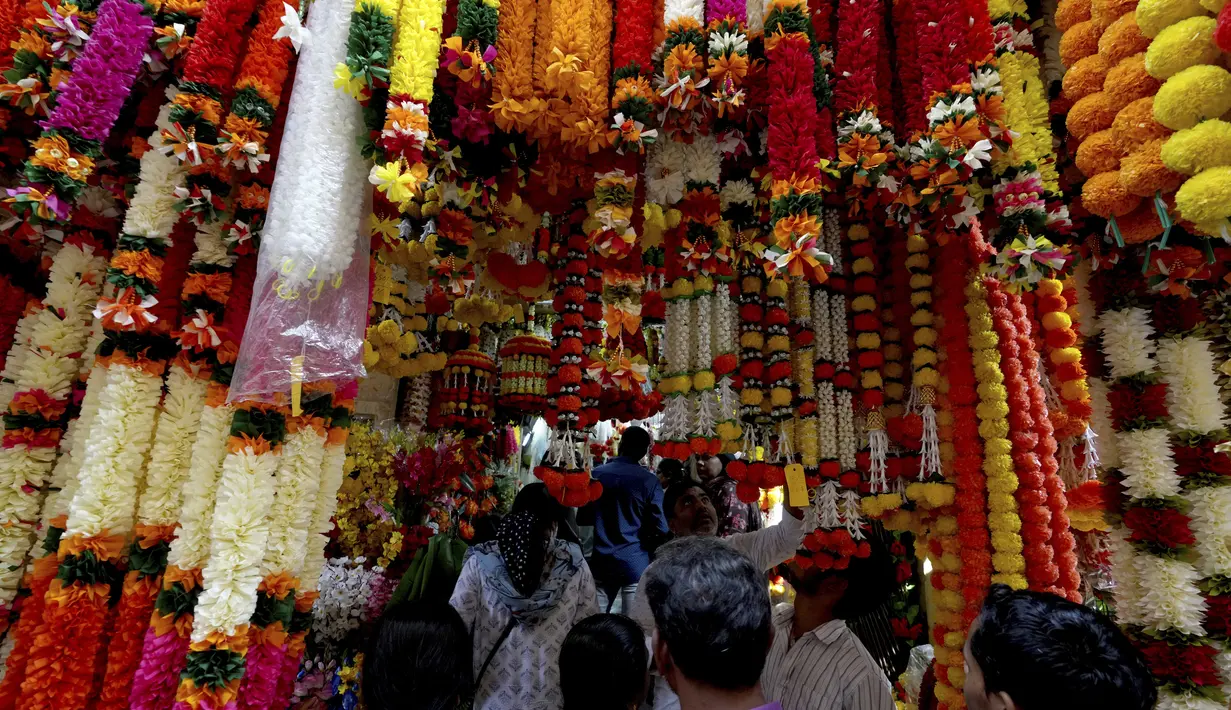Orang-orang berbelanja bunga buatan untuk menghias rumah dan toko mereka menjelang festival Diwali di Hyderabad, India, Kamis, 20 Oktober 2022. Diwali, Festival Cahaya akan dirayakan pada 24 Oktober. (AP Photo/Mahesh Kumar A )