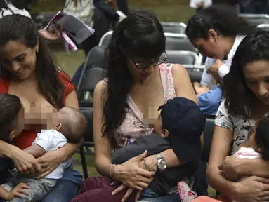 Sejumlah ibu-ibu menyusui anak mereka selama festival menyusui "Big latch On" yang diadakan di Bonatic Garden of the Chapultepec Park di Mexico City, Meksiko (5/8). Festival menyusui ini dipromosikan oleh UNICEF. (AFP Photo/Yuri Cotez)