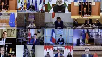 Sejumlah pemimpin dunia terlihat pada layar saat mengikuti KTT Luar Biasa G20 secara virtual dari Canberra, Australia, Kamis (26/3/2020). Para pemimpin dunia mengkoordinasikan respons global terhadap pandemi virus corona COVID-19. (Gary Ramage/POOL/AFP)