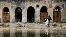 Anggota pasukan Presiden Suriah Bashar al-Assad berjalan di antara puing reruntuhan bangunan di kompleks Masjid Umayyad, Aleppo di Suriah, 13 Desember 2016. Konflik antara pemerintah dan pemberontak membuat masjid tersebut hancur. (REUTERS/Omar Sanadiki)