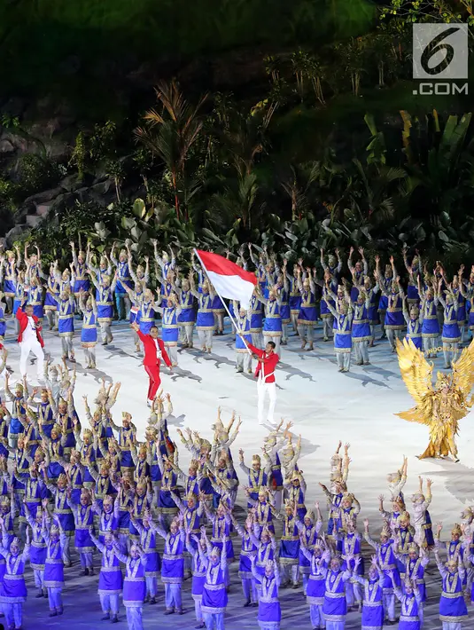 Atlet kontingen Indonesia memasuki stadion pada pembukaan Asian Games 2018 di Stadion Utama Gelora Bung Karno (SUGBK), Jakarta, Sabtu (18/8). Atlet renang I Gede Siman Sudartawa dipercaya menjadi pembawa bendera Merah Putih. (Liputan6.com/Ferbian Pradolo)