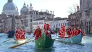 Ratusan orang mengenakan kostum Santa Claus mendayung perahu berparade di sepanjang Canal Grande di Venesia, Italia, (17/12). Sekitar dua ratus pendayung memberikan kehidupan pada prosesi air tradisional Santa Claus. (Andrea Merola / ANSA via AP)