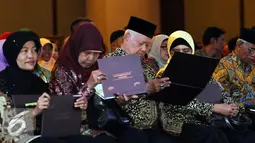 Sejumlah wisudawan program pemberdayaan usaha mikro dan purna bakti melihat sertifikat usai diwisuda di Bogor, Jawa Barat (16/12/2015). BTPN mewisuda 300 nasabah program pemberdayaan usaha mikro dan purna bakti. (Liputan6.com/Helmi Fithriansyah)