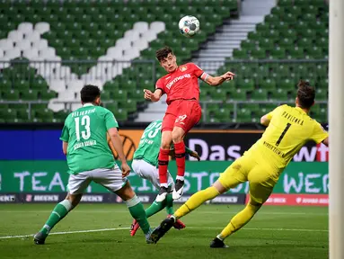 Pemain Bayer Leverkusen Kai Havertz (tengah) mencetak gol ke gawang Werder Bremen dalam pertandingan Bundesliga di Bremen, Jerman, Senin (18/5/2020). Bayer Leverkusen menang 4-1. (Stuart FRANKLIN/POOL/AFP)