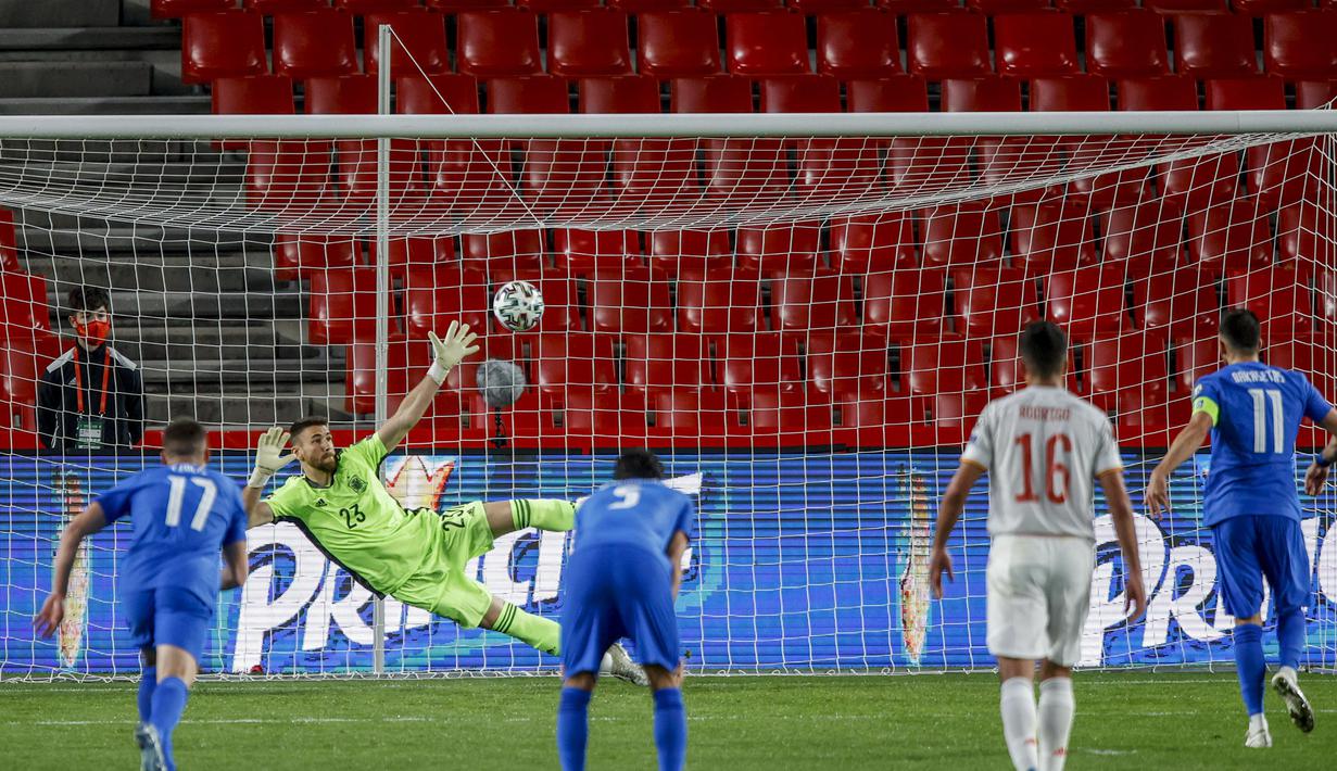 Gelandang Yunani, Anastasios Bakasetas (kanan) melakukan eksekusi penalti yang berbuah gol penyeimbang 1-1 ke gawang Spanyol dalam laga Kualifikasi Piala Dunia 2022 Zona Eropa Grup B di Los Carmenes Stadium, Granada, Kamis (25/3/2021). Yunani bermain imbang 1-1 dengan Spanyol. (AP/Fermin Rodriguez)