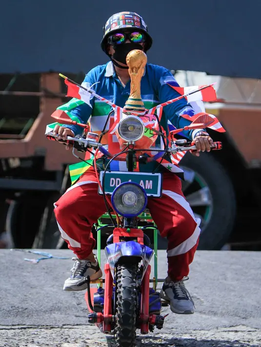 Seorang penggemar sepak bola berpartisipasi dalam konvoi menyambut turnamen sepak bola Piala Dunia 2026 di Polewali Mandar, Sulawesi Barat, Kamis 11 Juni 2026. (Muhammad SALIM/AFP)