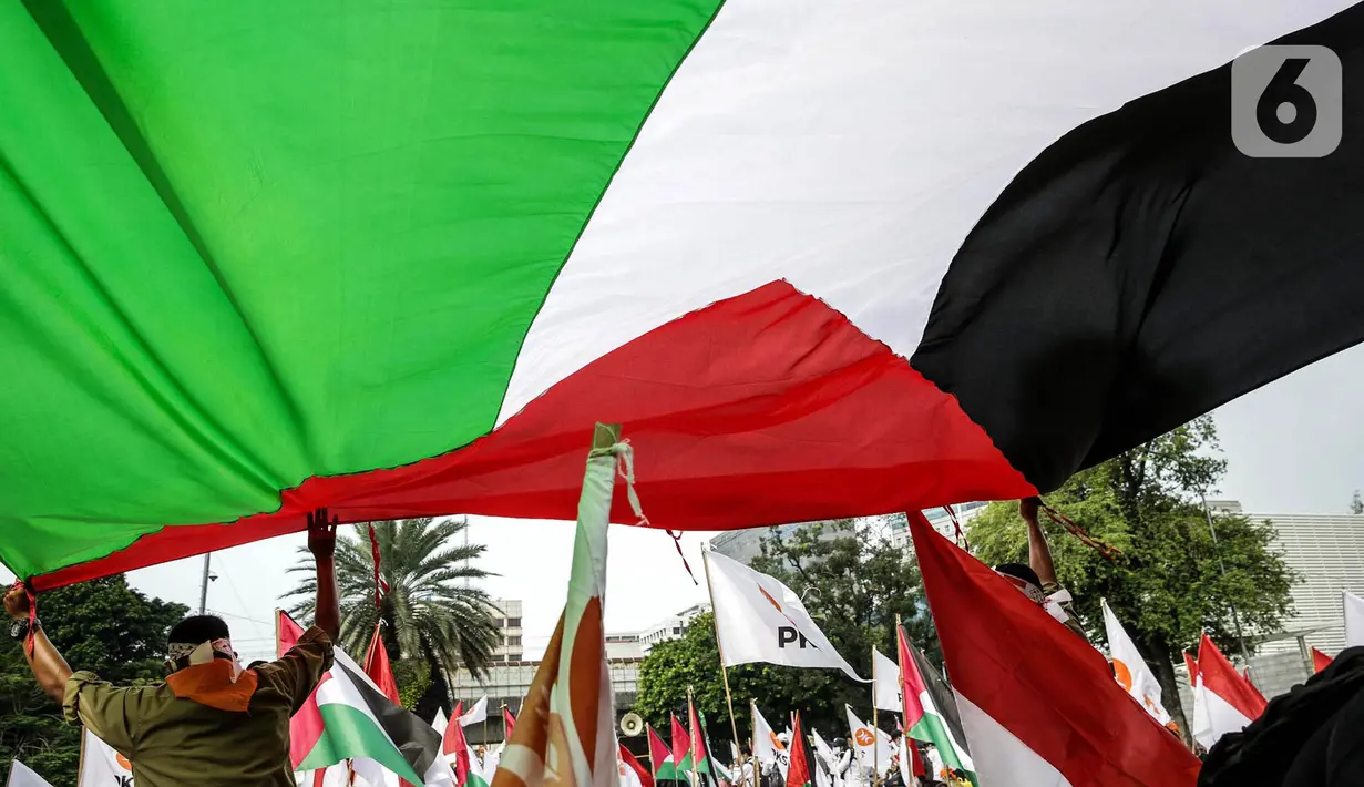 Peserta kader Partai Keadilan Sejahtera (PKS) mengibarkan bendera Palestina di depan Kedutaan Besar Amerika Serikat, Jakarta, Kamis (20/5/2021). Aksi tersebut dalam rangka berempati kepada bangsa Palestina untuk mendapatkan kemerdekaannya dari serangan Israel. (Liputan6.com/Faizal Fanani)