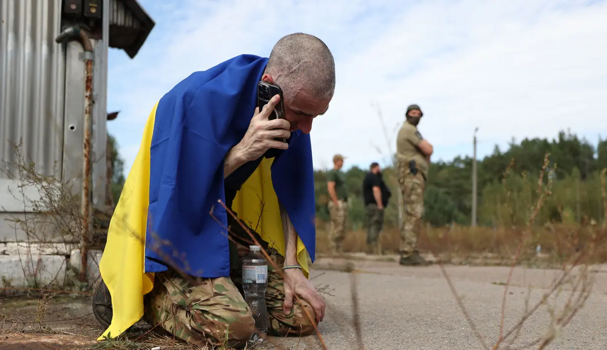 Seorang prajurit Ukraina menelepon setelah dibebaskan dari tawanan Rusia di sebuah lokasi yang dirahasiakan di dekat perbatasan Ukraina-Belarusia, pada 13 September 2024. (Anatolii STEPANOV/AFP)