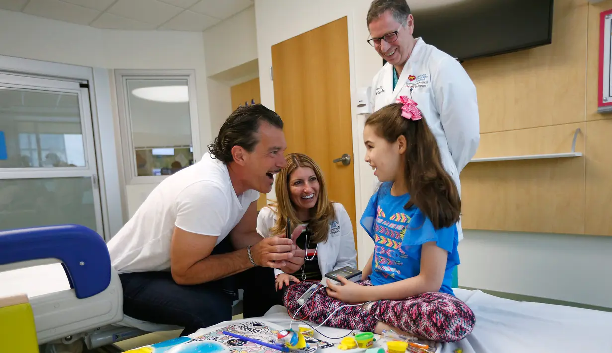Antonio Banderas berbincang dengan pasien anak di Rumah Sakit Anak-anak Nicklaus di Miami, Florida, AS, Selasa (30/5). Antonio kini berperan aktif dalam organisasi yang bergerak di bidang sosial. (AP/David Santiago / El Nuevo Herald)