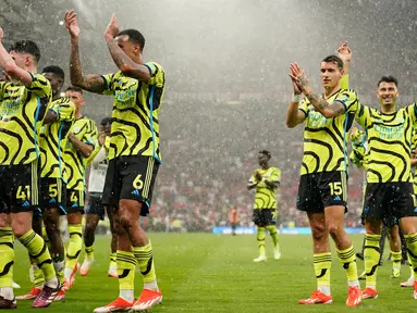 Para pemain Arsenal melakukan selebrasi setelah memenangkan pertandingan sepak bola Liga Premier Inggris melawan Manchester United di Stadion Old Trafford, Manchester, Inggris, Minggu, 12 Mei 2024. (AP Photo/Dave Thompson)