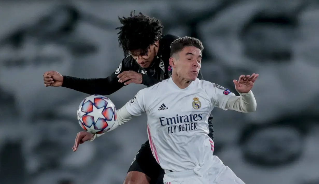 Gelandang Real Madrid, Sergio Arribas Calvo berebut bola dengan pemain Borussia Monchengladbach, Valentino Lazaro pada pertandingan Grup B Liga Champions di Estadio Alfredo Di Stefano, Kamis (10/12/2020). Madrid menang atas Monchengladbach 2-0. (AP Photo/Bernat Armangue)