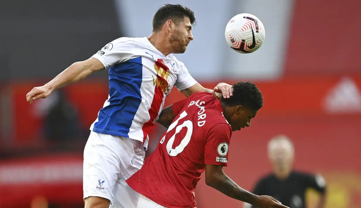 Penyerang Manchester United, Marcus Rashford, duel udara dengan pemain Crystal Palace, Joel Ward, pada laga Premier League di Stadion Old Trafford, Sabtu (19/9/2020). Setan Merah takluk dengan skor 1-3. Crystal Palace. (Shaun Botterill/Pool via AP)