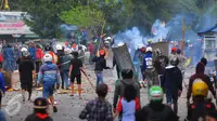 Dua kelompok warga terlibat tawuran di dekat Stasiun Manggarai, Jakarta Selatan, Minggu (8/1).  Puluhan orang terlihat membawa senjata tajam, bongkahan batu dan petasan. (Liputan6.com/Angga Yuniar)