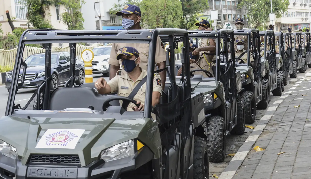 Personel polisi duduk di kendaraan segala medan (ATV) yang digunakan untuk berpatroli di pantai selama peluncurannya di Mumbai, Senin (7/6/2021). ATV ini juga akan dikerahkan dalam beberapa operasi penyelamatan di mana kendaraan normal tidak dapat mencapainya. (Sujit Jaiswal / AFP)