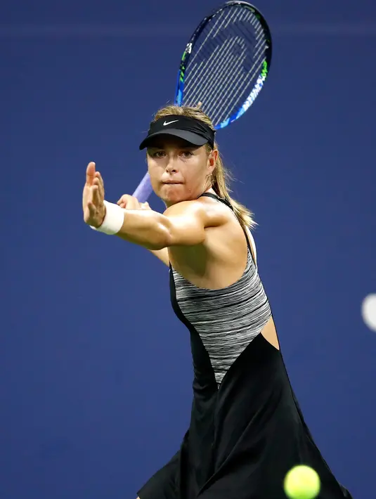Petenis Rusia, Maria Sharapova mengembalikan bola Patty Schnyder dari Swiss pada pertandingan tunggal pertama putri AS Terbuka 2018 di New York, (28/8). Sharapova menang dua set langsung 6-2, 7-6 (6). (AFP Photo/Julian Finney)