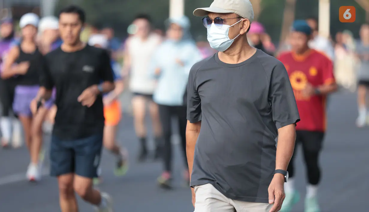 Sejumlah warga tetap berlari saat mengikuti aktivitas olahraga di kawasan Car Free Day (CFD) Jakarta di tengah kondisi udara yang terdampak sebaran abu vulkanik, Minggu (6/9/2026). (KLY/Budy Santoso)