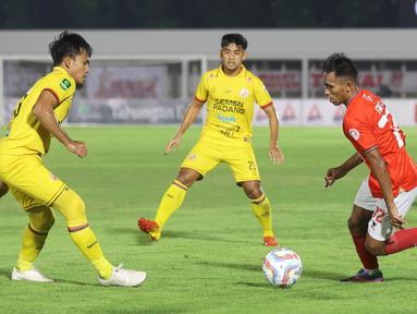 Pemain Malut United, Frets Butuan, berusaha melewati pemain Semen Padang pada laga leg pertama semifinal Pegadaian Liga 2 2023/2024 di Stadion Madya, Jakarta, Minggu (25/02/2024). (Bola.com/M Iqbal Ichsan)