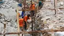 Pekerja memasang batu membuat pondasi turap jalan dalam pengerjaan proyek penataan ulang Kalijodo, Jakarta (18/3). Pengerjaan di sepanjang Jalan Kepanduan II, mulai dari ujung di Jalan Teluk Gong, hingga Jalan Tubagus Angke. (Liputan6.com/Gempur M Surya)