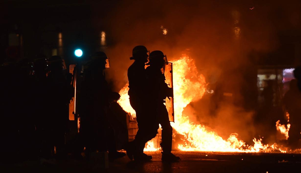 Polisi berusaha mengamankan fans Marseille yang bertindak anarkis usai tim nya kalah dari Atletico Madrid final Liga Europa di Vieux Port, Prancis, Rabu, (16/5/2018). Atletico Madrid menang 3-0 atas Marseille. (AFP/ Bertrand Langlois)