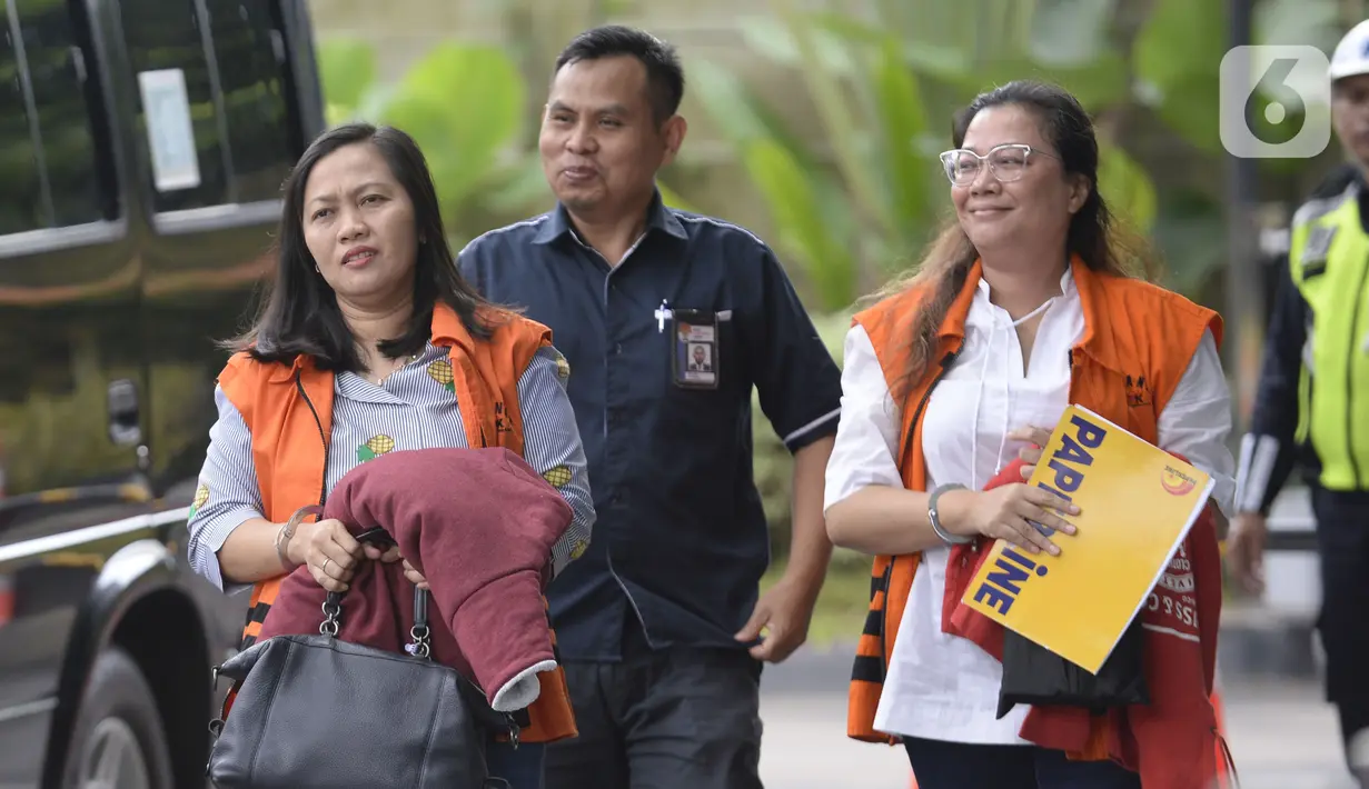 Indung selaku orang kepercayaan mantan anggota DPR dari Fraksi Golkar, Bowo Sidik Pangarso (kiri) dan mantan anggota Bawaslu, Agustiani Tio Fridelina (kanan) berjalan akan menjalani pemeriksaan di Gedung KPK, Jakarta, Selasa (4/ 2/2020). (merdeka.com/Dwi Narwoko)