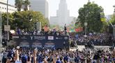 Para pemain, pelatih, ofisial tim Los Angeles Dodgers melakukan pawai di atas bus mengelilingi kota Los Angeles, California setelah berhasil menjuarai 2025 World Series Championship pada Senin (03/11/2025) waktu setempat. (AP Photo/Kyusung Gong)
