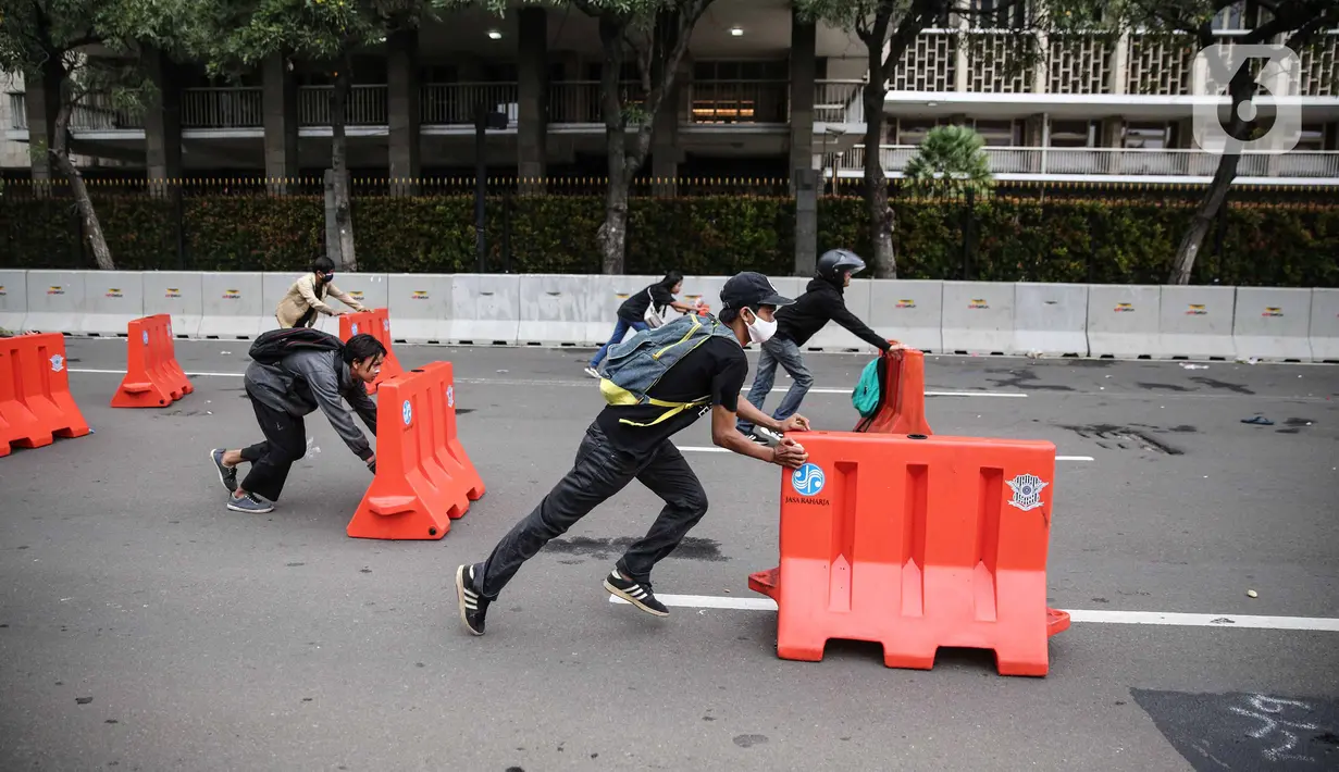 Pengunjuk rasa terlibat bentrok dengan aparat kepolisian di sekitar Patung Kuda, Jakarta Pusat, Selasa (13/10/2020). Unjuk rasa  menolak Omnibus Law Undang-Undang Cipta Kerja tersebut ricuh. (Liputan6.com/Faizal Fanani)