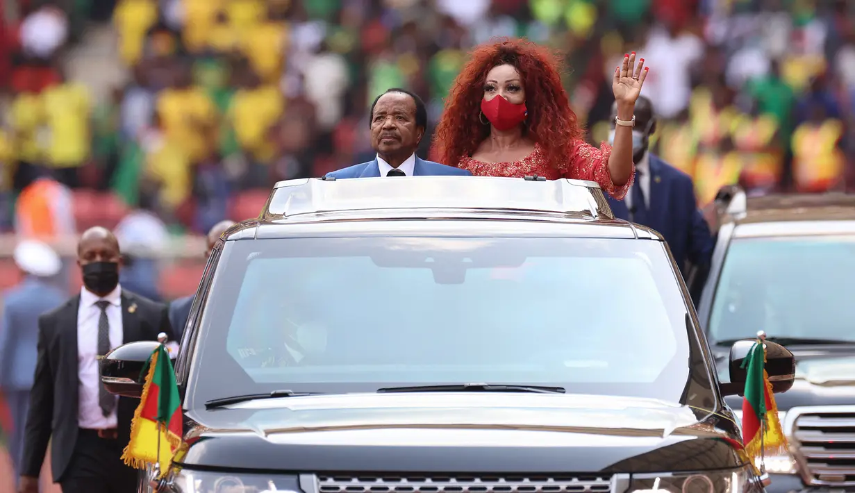 Presiden Kamerun Paul Biya (dan Ibu Negara Kamerun Chantal Biya melambai ke penonton selama upacara pembukaan turnamen sepak bola Piala Afrika (CAN) 2021 di Stade d'Olembé di Yaounde (9/1/2022). Kamerun untuk kali kedua menjadi tuan rumah Piala Afrika setelah pada 1972. (AFP/Kenzo Tribouillard)