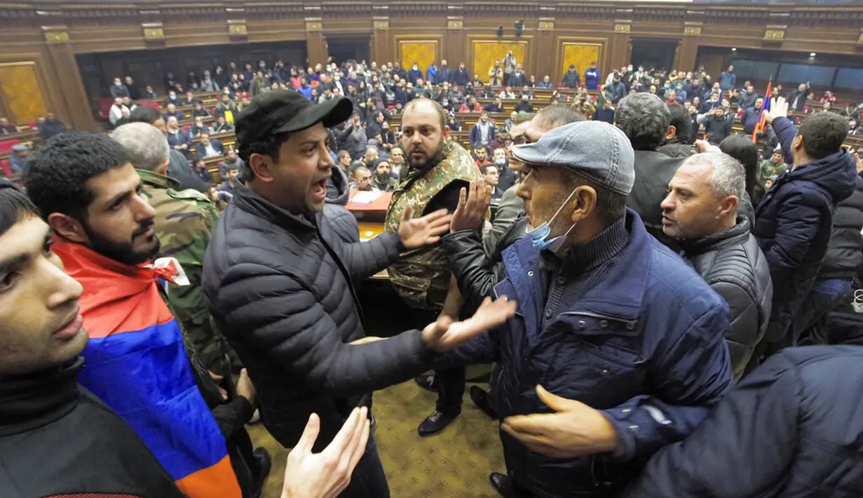 Demonstran berdebat saat mereka masuk ke Gedung Parlemen memprotes kesepakatan untuk menghentikan pertempuran di wilayah Nagorno-Karabakh, Yerevan, Armenia, Selasa (10/11/2020). PM Armenia Nikol Pashinian menyerukan diakhirinya pertempuran dengan Azerbaijan. (AP Photo/Dmitri Lovetsky)