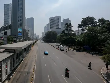 Ruas jalan protokol terlihat lengang di kawasan Jalan Thamrin mengarah ke Sudirman, Jakarta, Kamis (18/6/2015). Pada hari pertama puasa Ramadan 1436 H, beberapa titik jalan terlihat lengang dan sepi dari aktivitas warga. (Liputan6.com/Faizal Fanani)