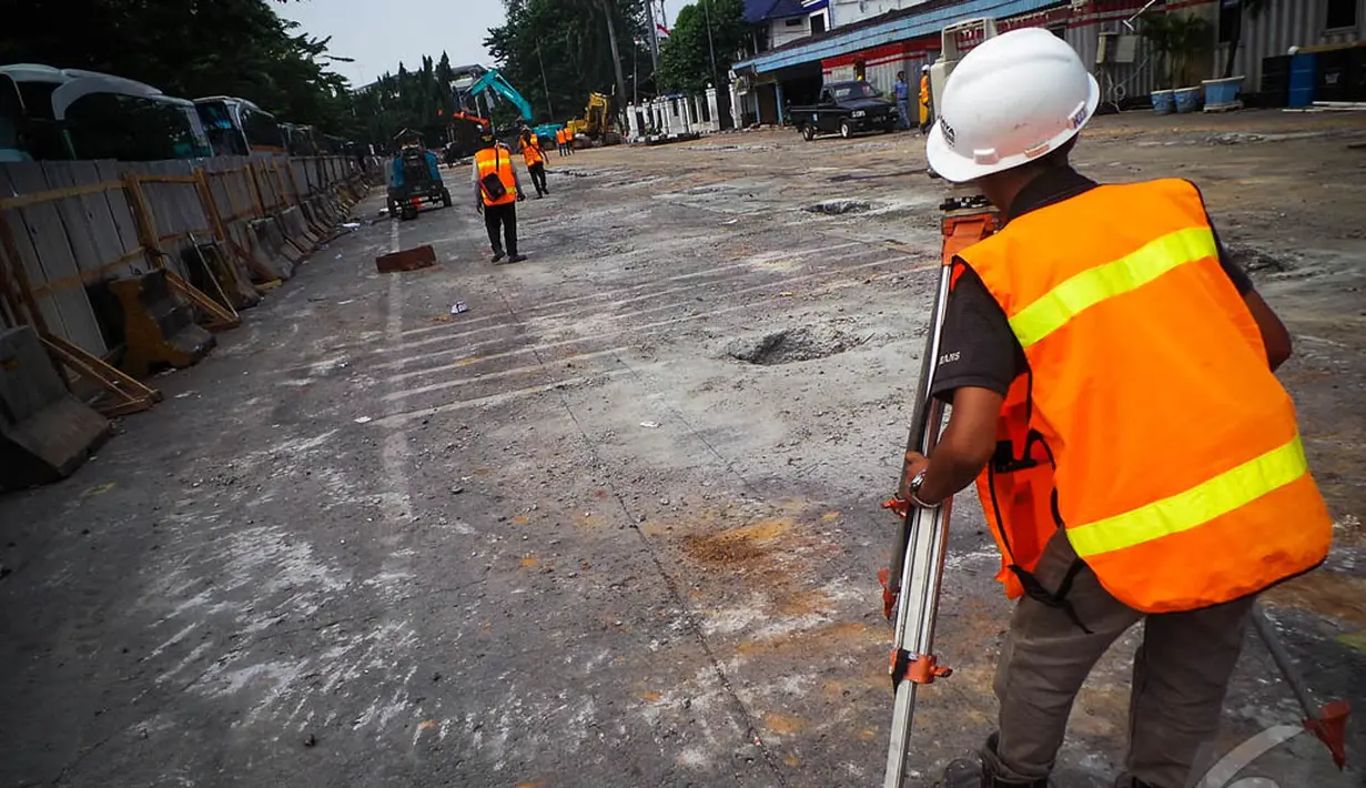 Seorang petugas sedang mengukur tingkat kemiringan tanah yang akan dijadikan pondasi, Jakarta, Rabu (20/8/2014) (Liputan6.com/Faizal Fanani)