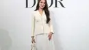 Ia padukan blazer broken white dengan rok tutu putih dan J'Adior Sling Back Pump