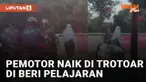 Aksi pemotor paksa melewati trotoar dihadang oleh dua pejalan kaki mengundang perhatian