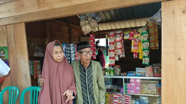 Nenek Nuru dan kakek Tahir, di depan kios yang dibangun dari bantuan masyarakat Indonesia melalui Liputan6.com, kitabisa.com dan YPP SCTV-Indosiar, Jumat (20/12/2019).(Liputan6.com/Ahmad Akbar Fua)