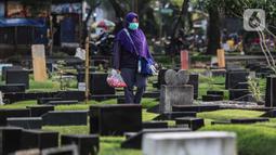 Warga berziarah di makam keluarganya di Tempat Pemakaman Umum (TPU) Tanah Kusir, Jakarta, Selasa (29/3/2022). TPU setempat semakin banyak dikunjungi warga yang melakukan tradisi ziarah kubur menjelang Ramadhan. (Liputan6.com/Johan Tallo)